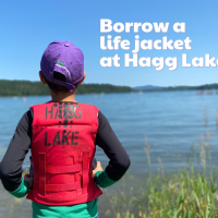 youth in a life jacket lakeside